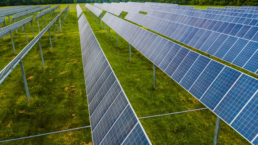 Solar modules on green field in photovoltaic station